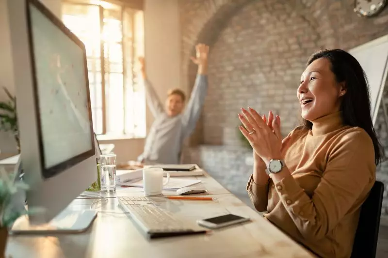 woman celebrates success with her colleague